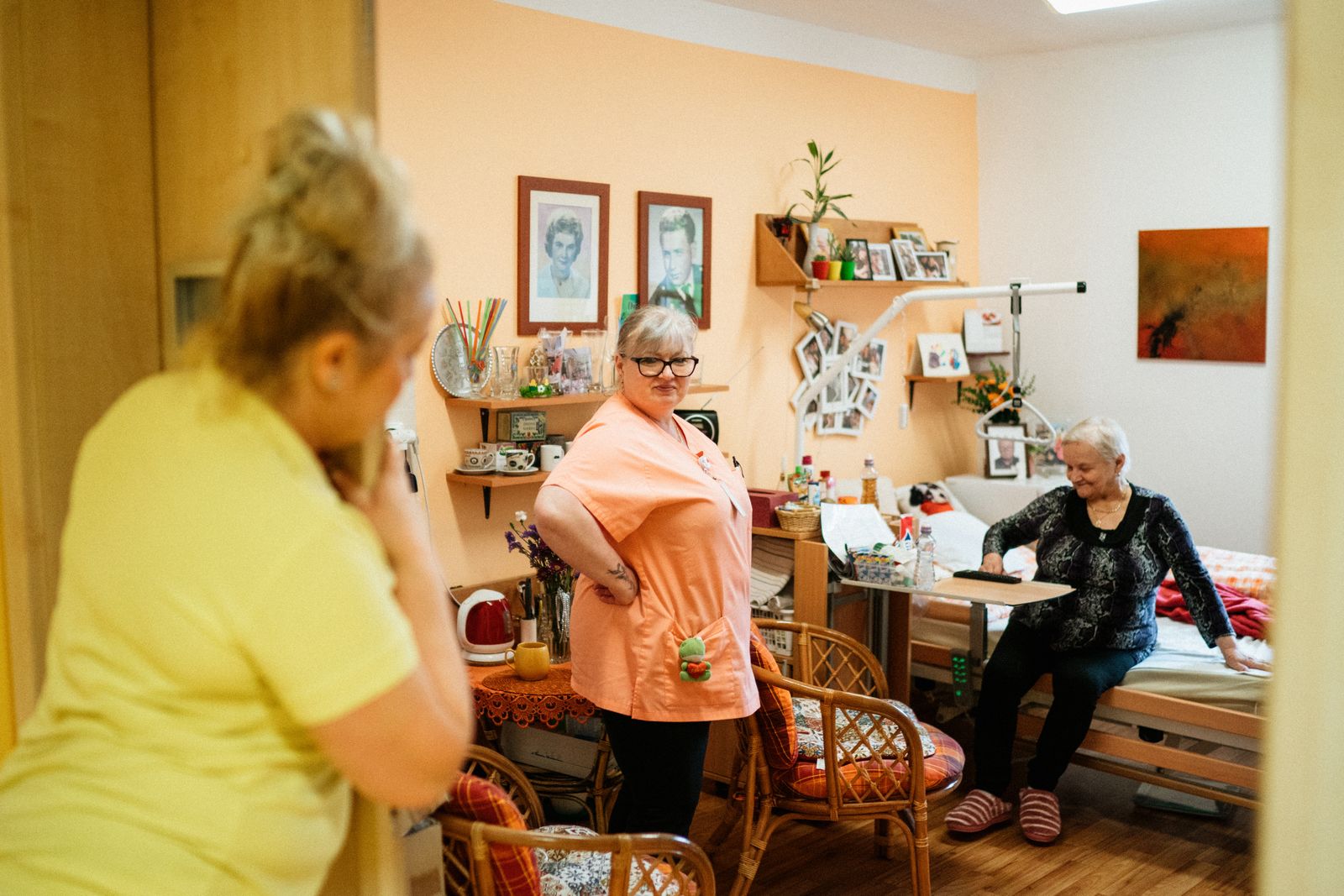 Care workers and residents together in a care home lounge