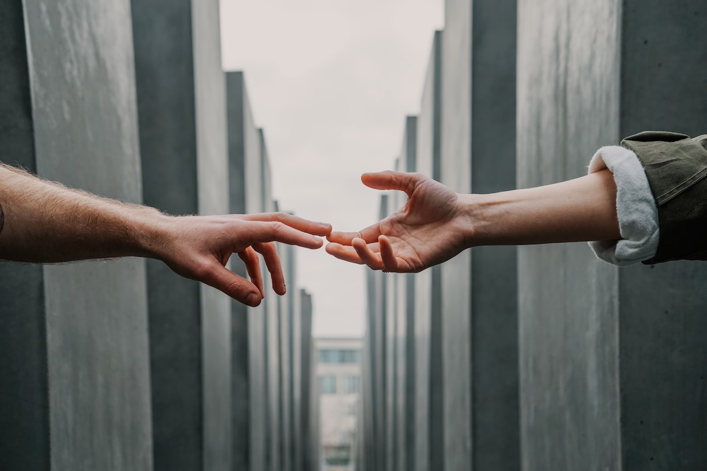 Two hands reaching towards one another