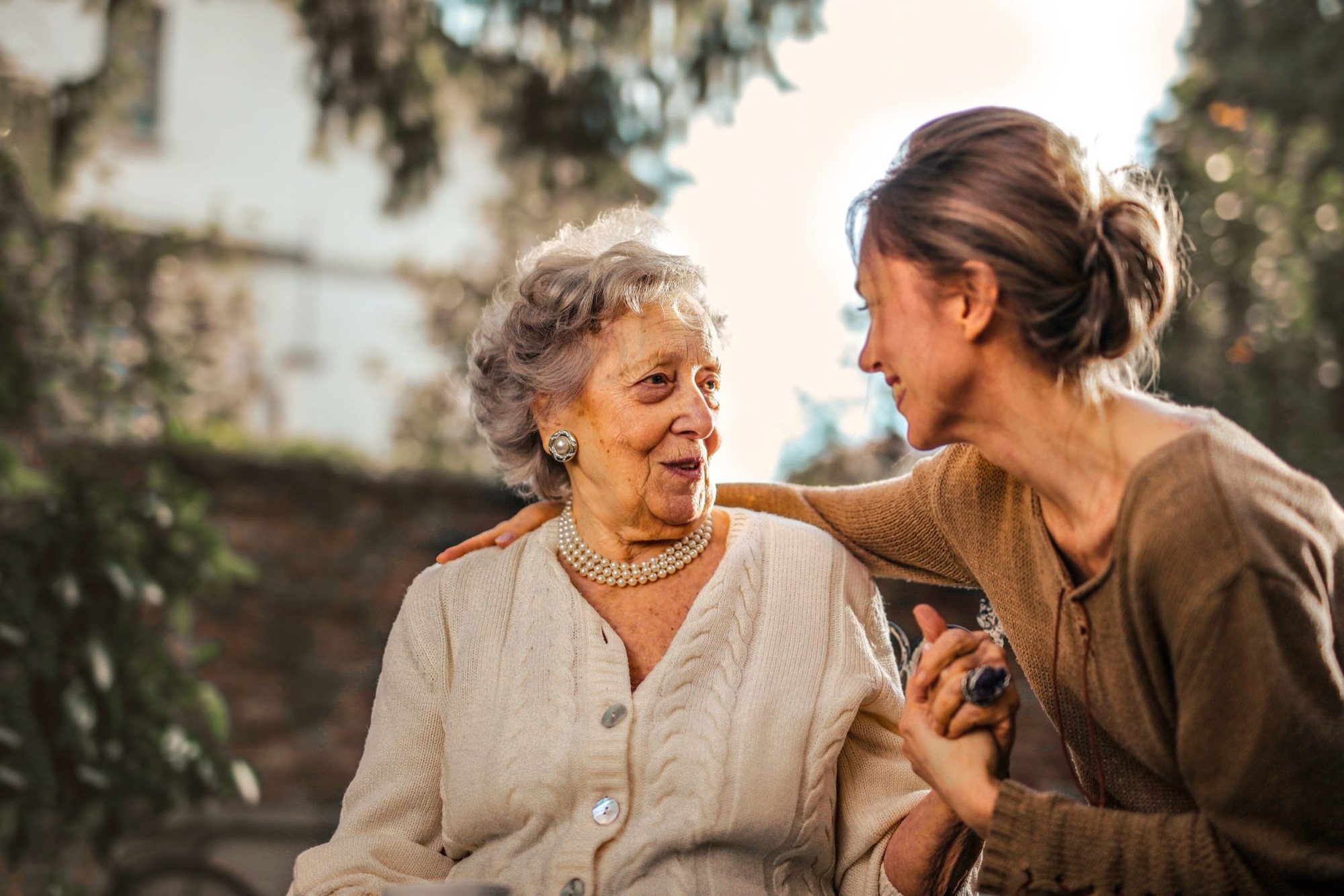 A PowerCare carer laughing with an older woman outdoors